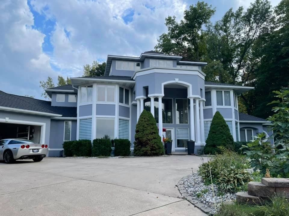 A large house with a car parked in front of it