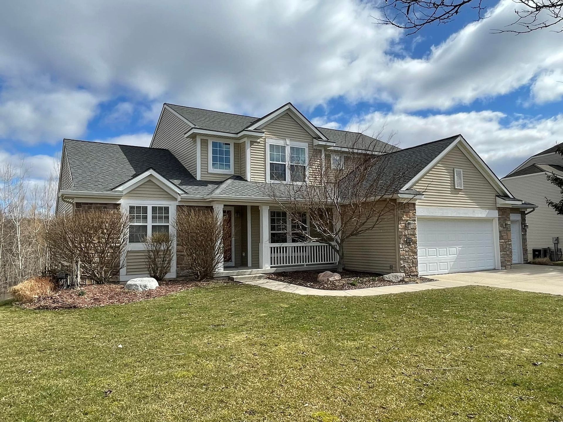 A large house with a large lawn in front of it.