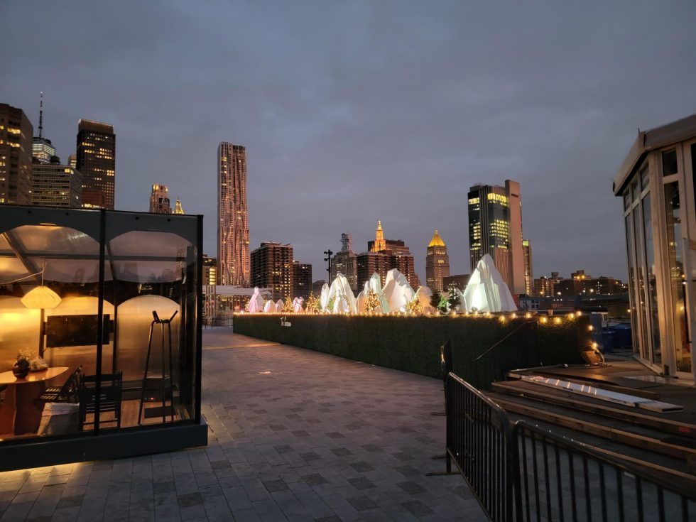 A Fenced In Area With A City Skyline In The Background