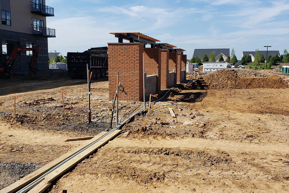 An Electrician Is Working On An Electrical Outlet With A Multimeter
