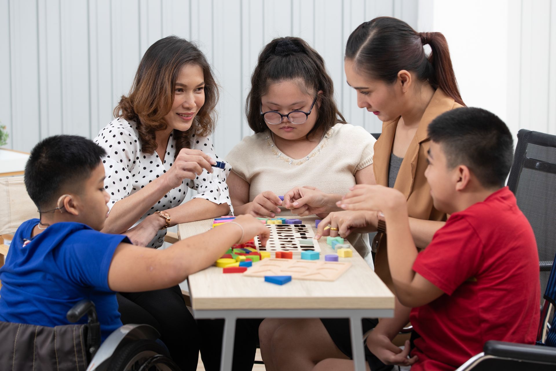 A group of people are sitting around a table playing a board game.