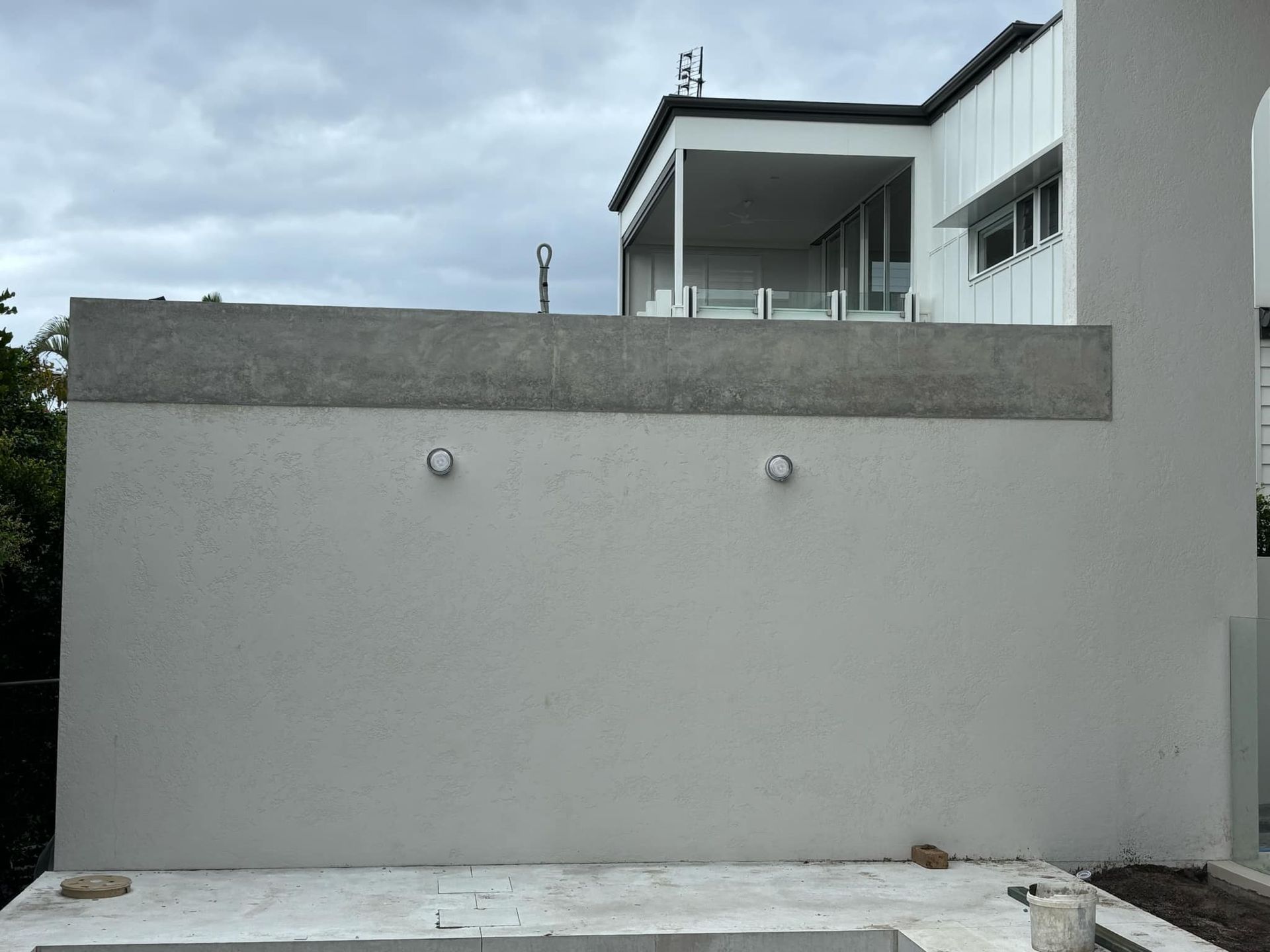 A large white building with a swimming pool in front of it