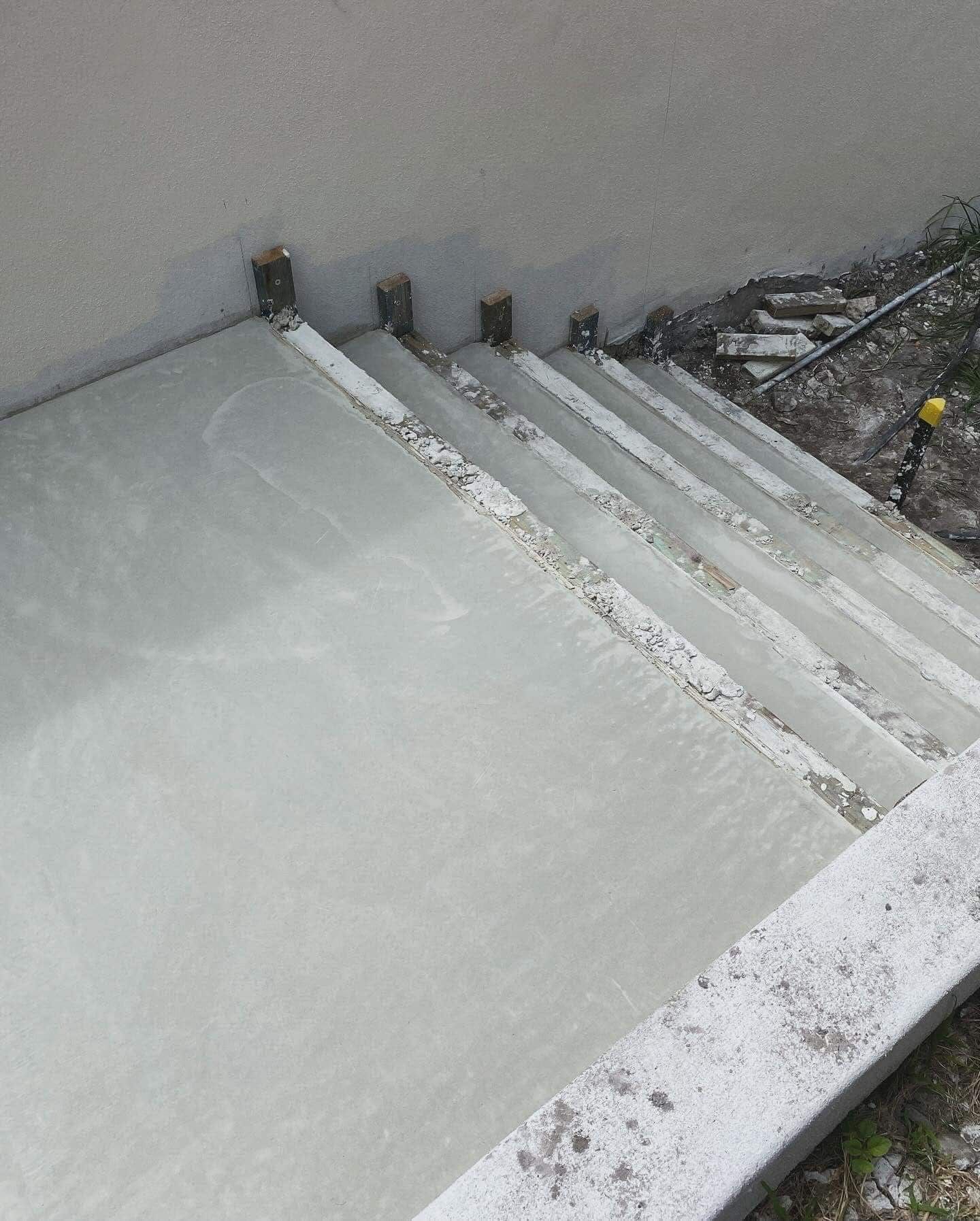 A concrete staircase is being built next to a wall on the Sunshine Coast