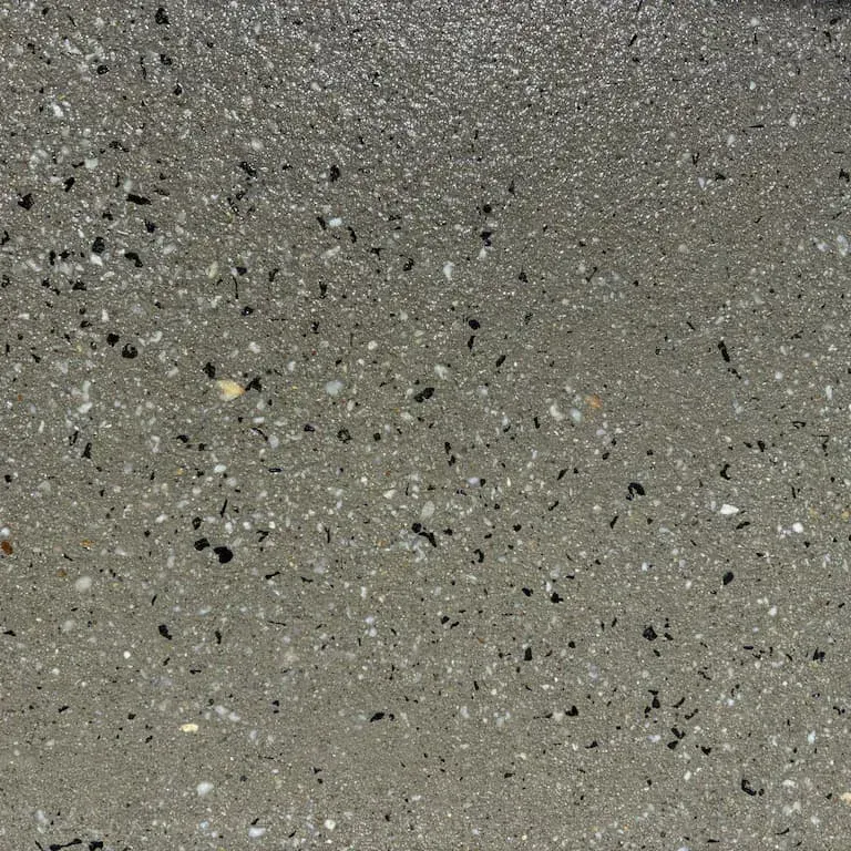 A close up of a gray surface with black spots