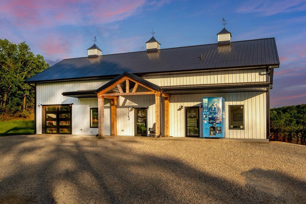 A group of people are playing frisbee in a park at sunset.