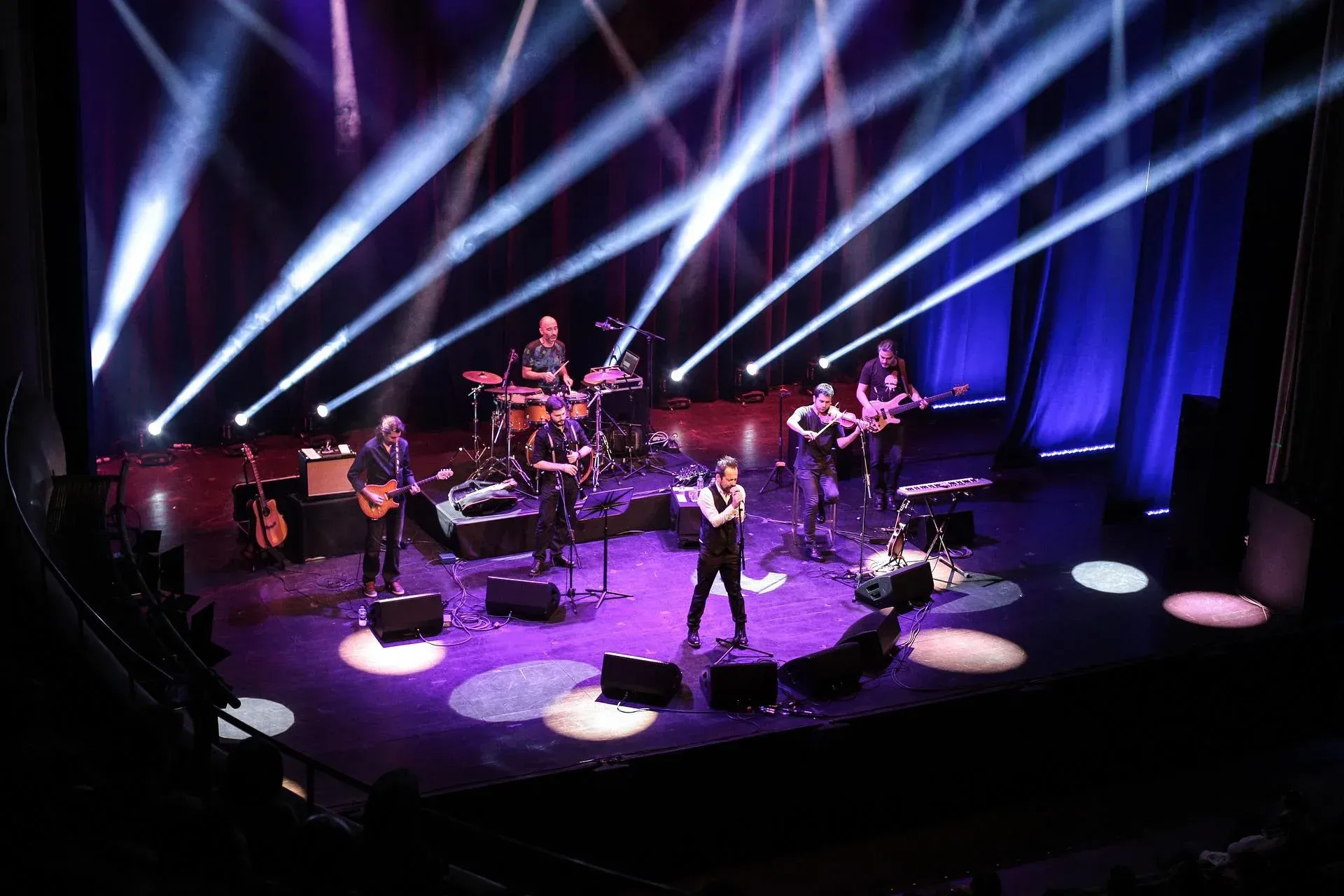 A group of people are playing instruments on a stage.