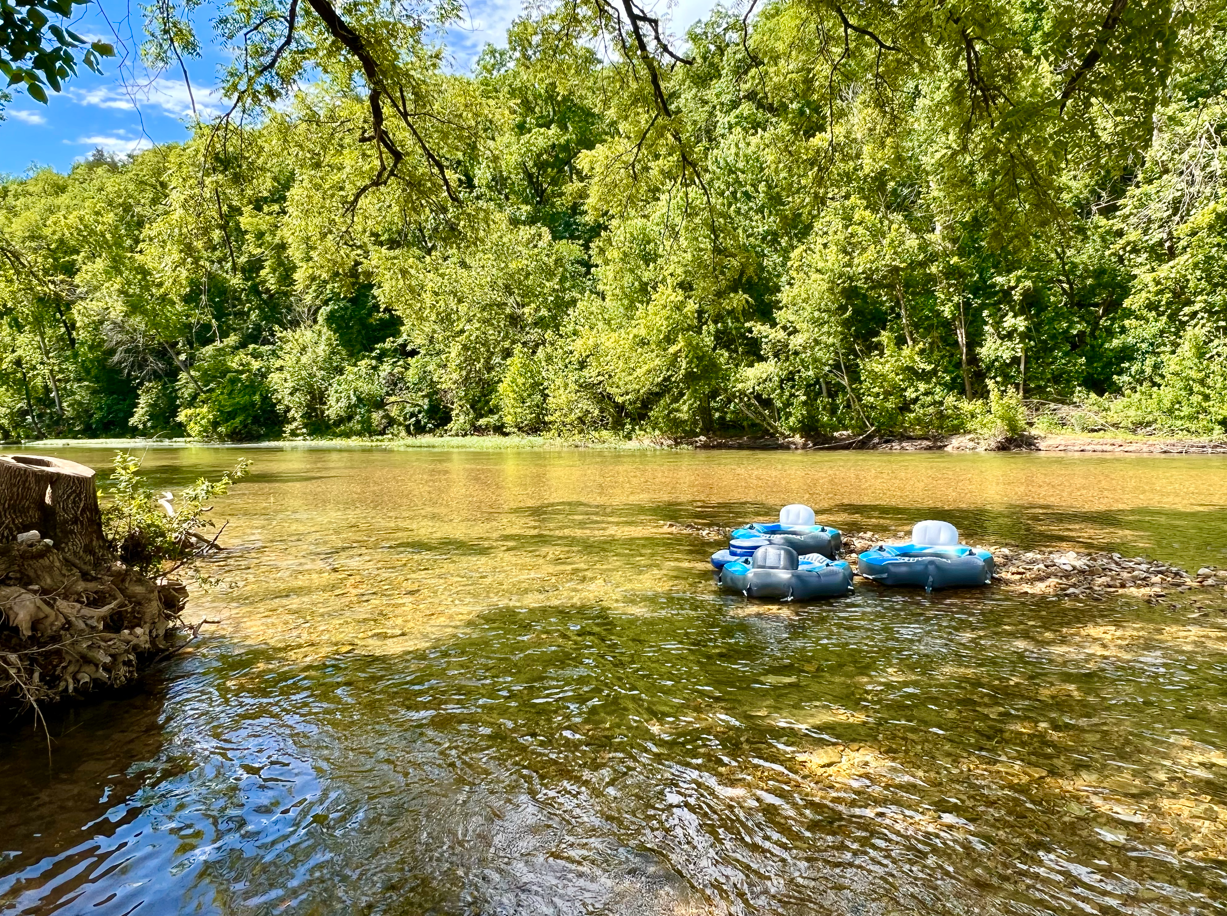 A couple of rafts are floating on top of a river.