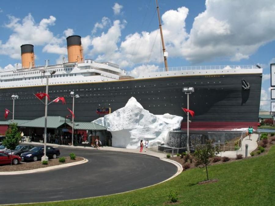 A large cruise ship is parked in a parking lot