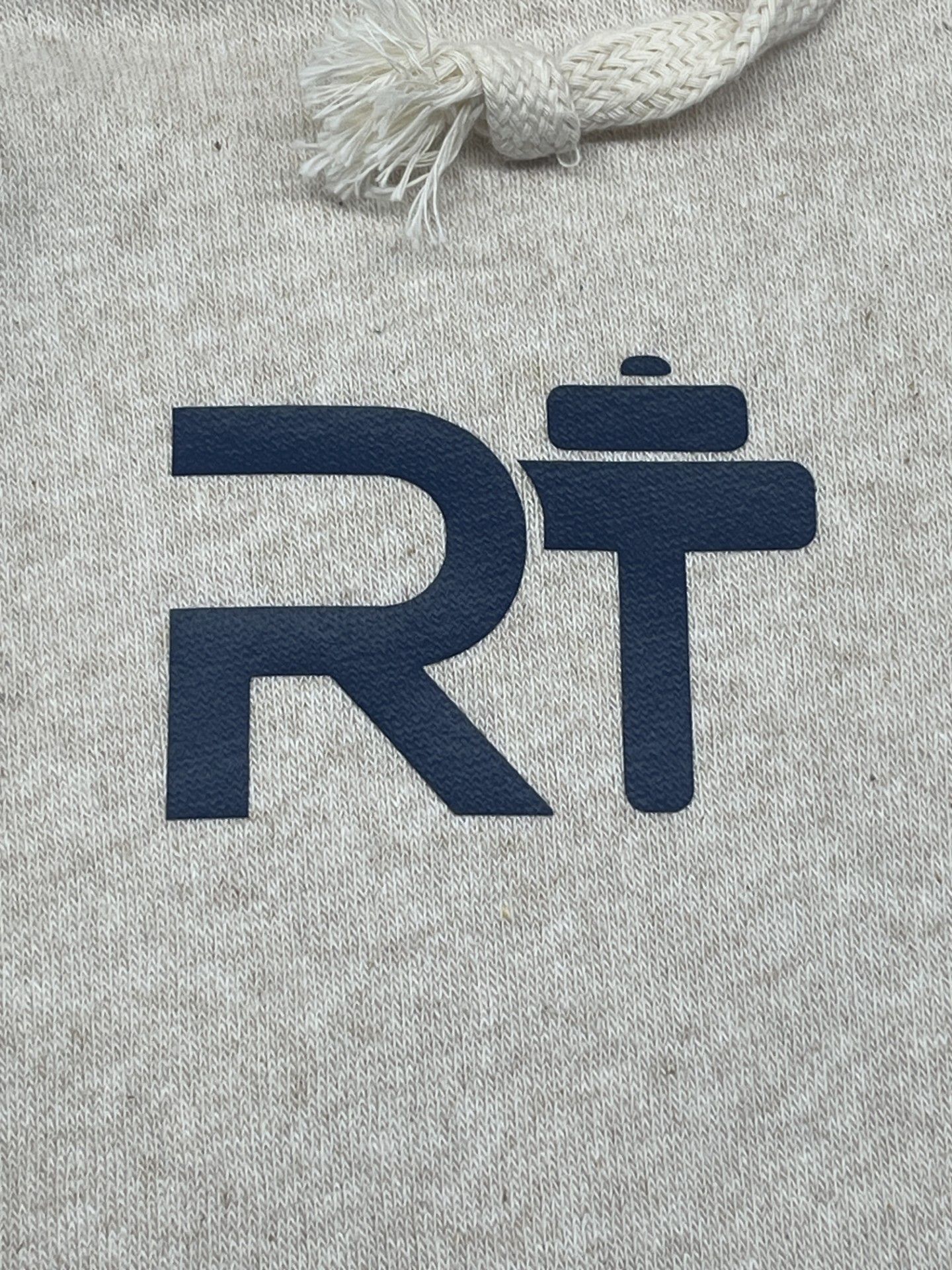 A close up of a hoodie with the letter r on it.