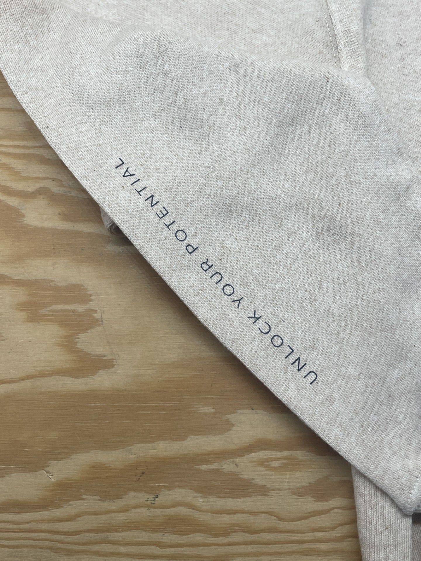 A close up of a sweatshirt with the words `` unlock your potential '' written on it.