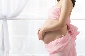Pregnant woman holding her stomach