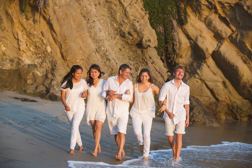 A group of people are walking on the beach.