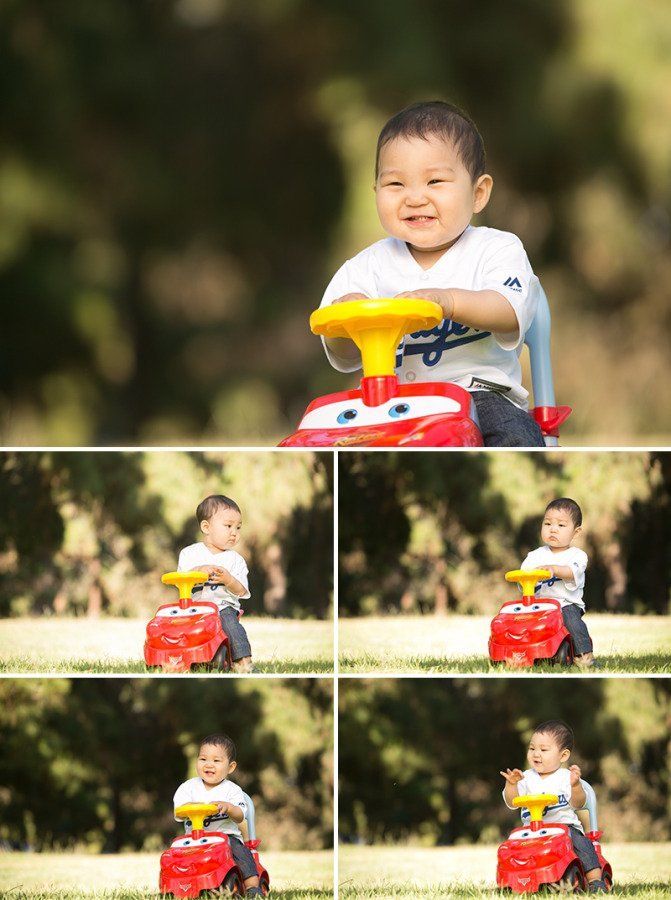 A young boy is riding a toy car in a park.