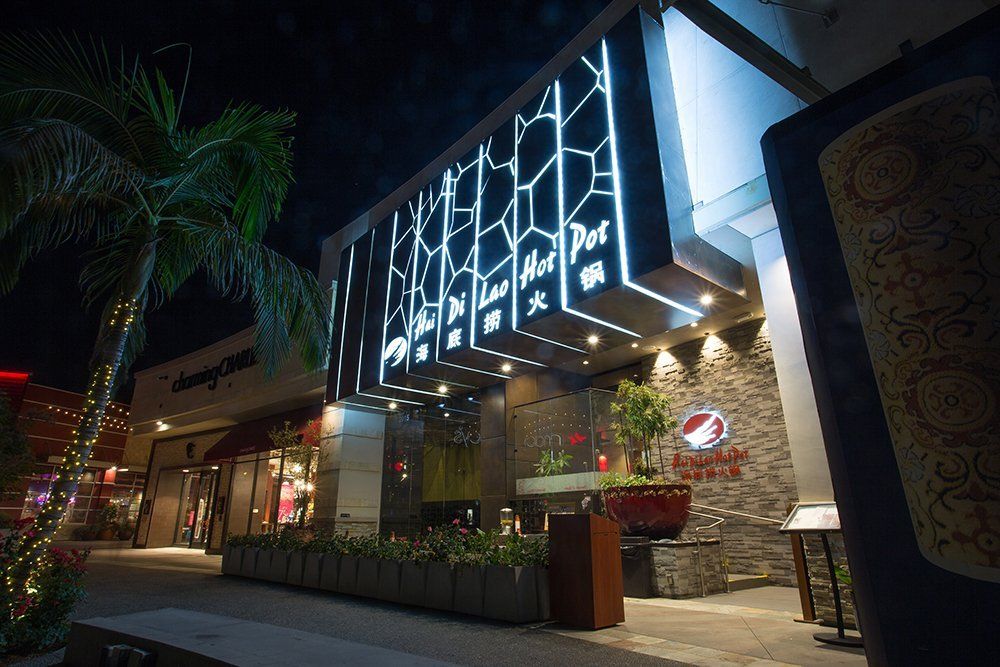 A large building with a lot of lights on it is lit up at night.