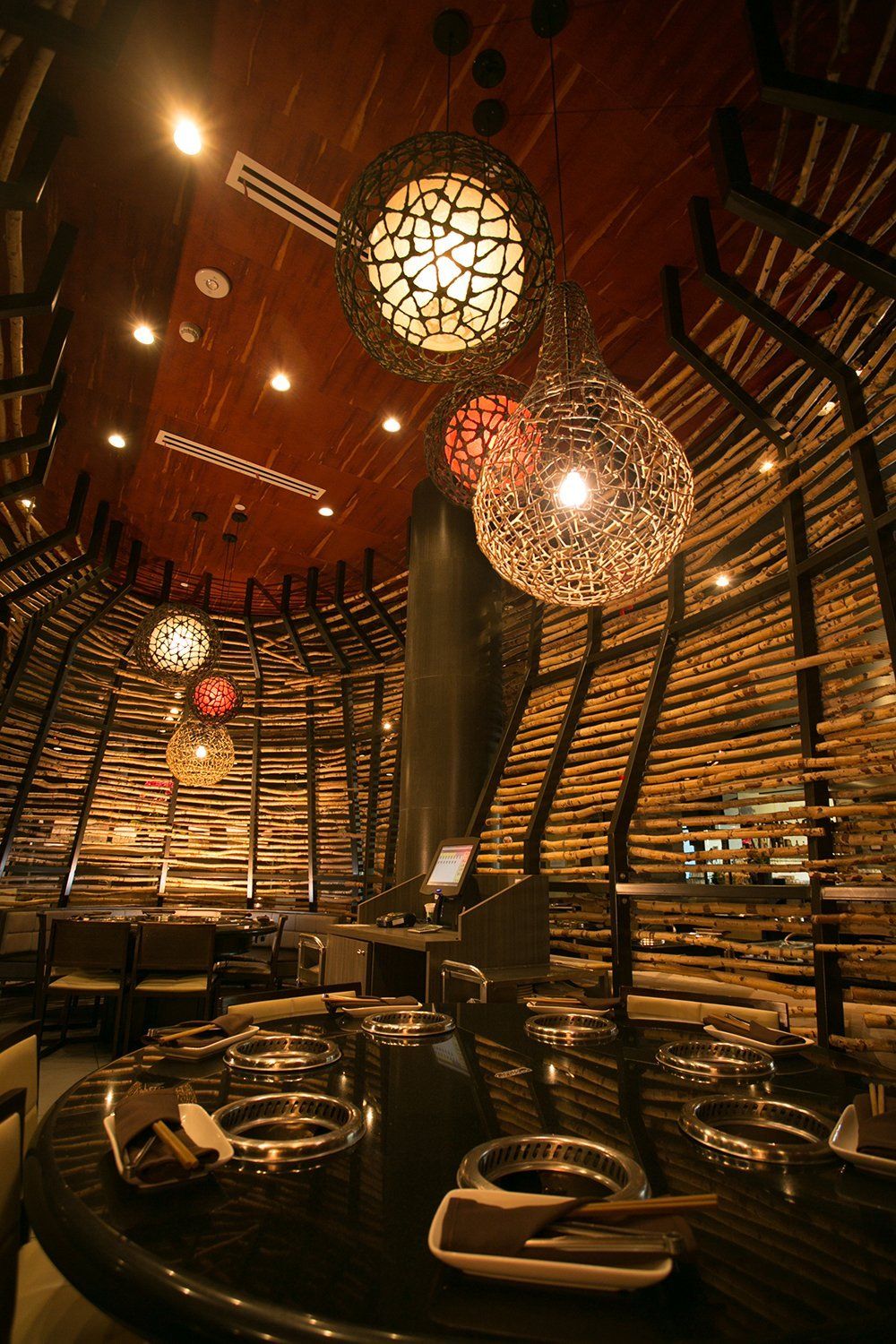 A restaurant with a lot of lights hanging from the ceiling