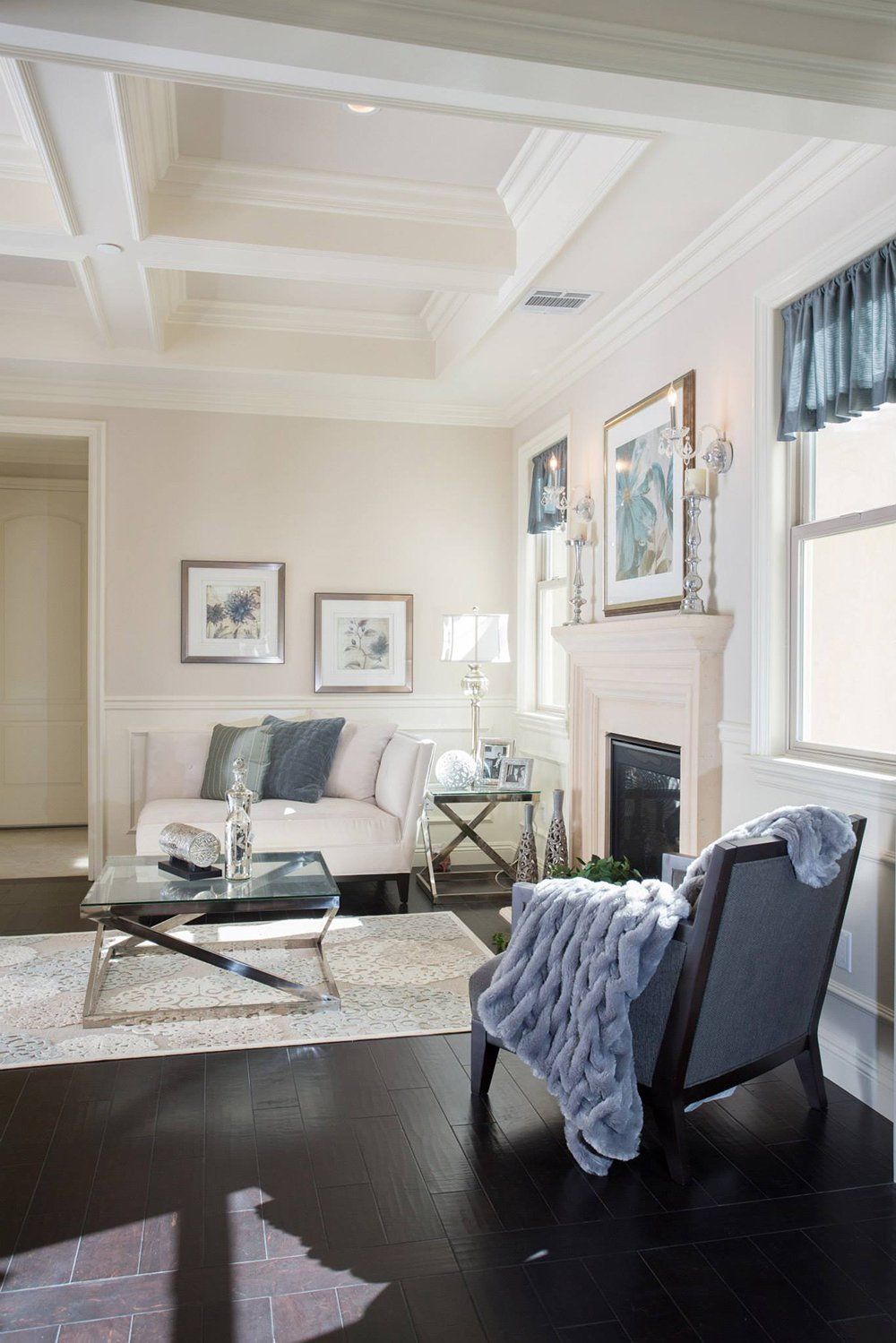 A living room with a couch , chair , coffee table and fireplace.