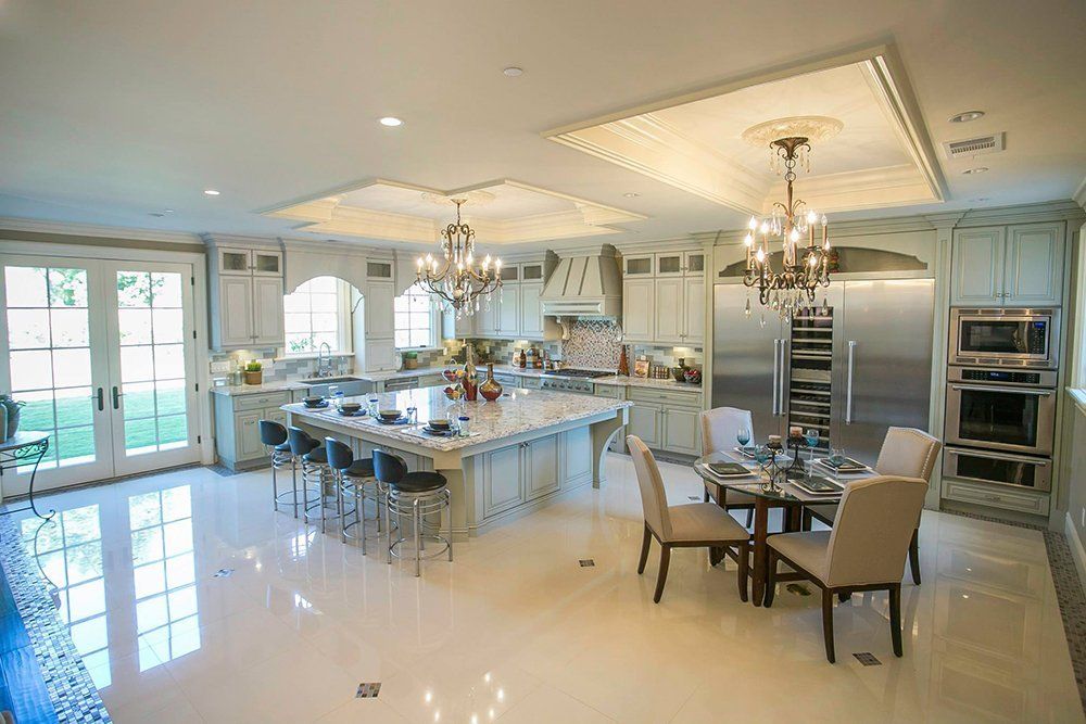 A large kitchen with a dining table and chairs and a large island.