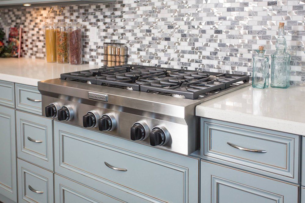 A stove top oven is sitting on top of a counter in a kitchen.