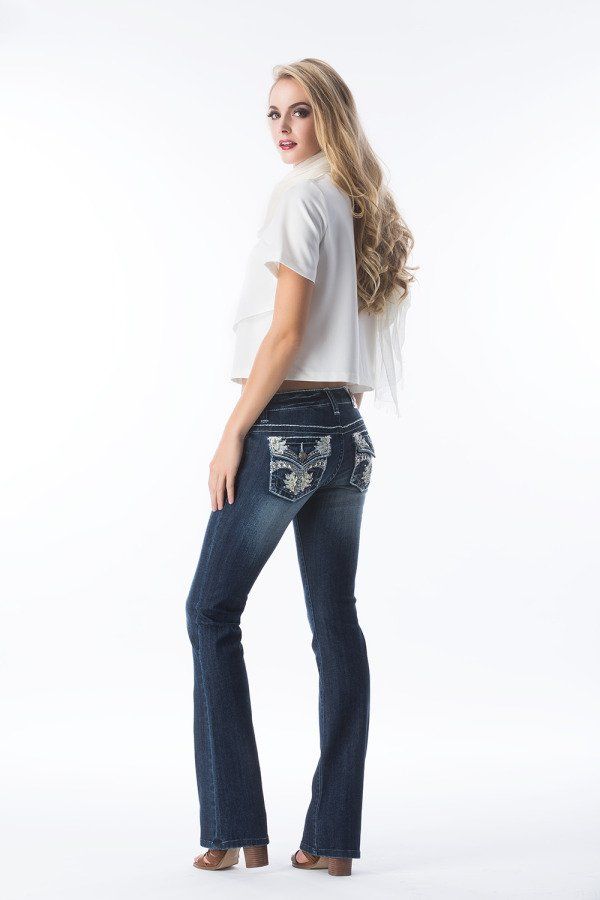 A woman in a white shirt and blue jeans is standing on a white background.