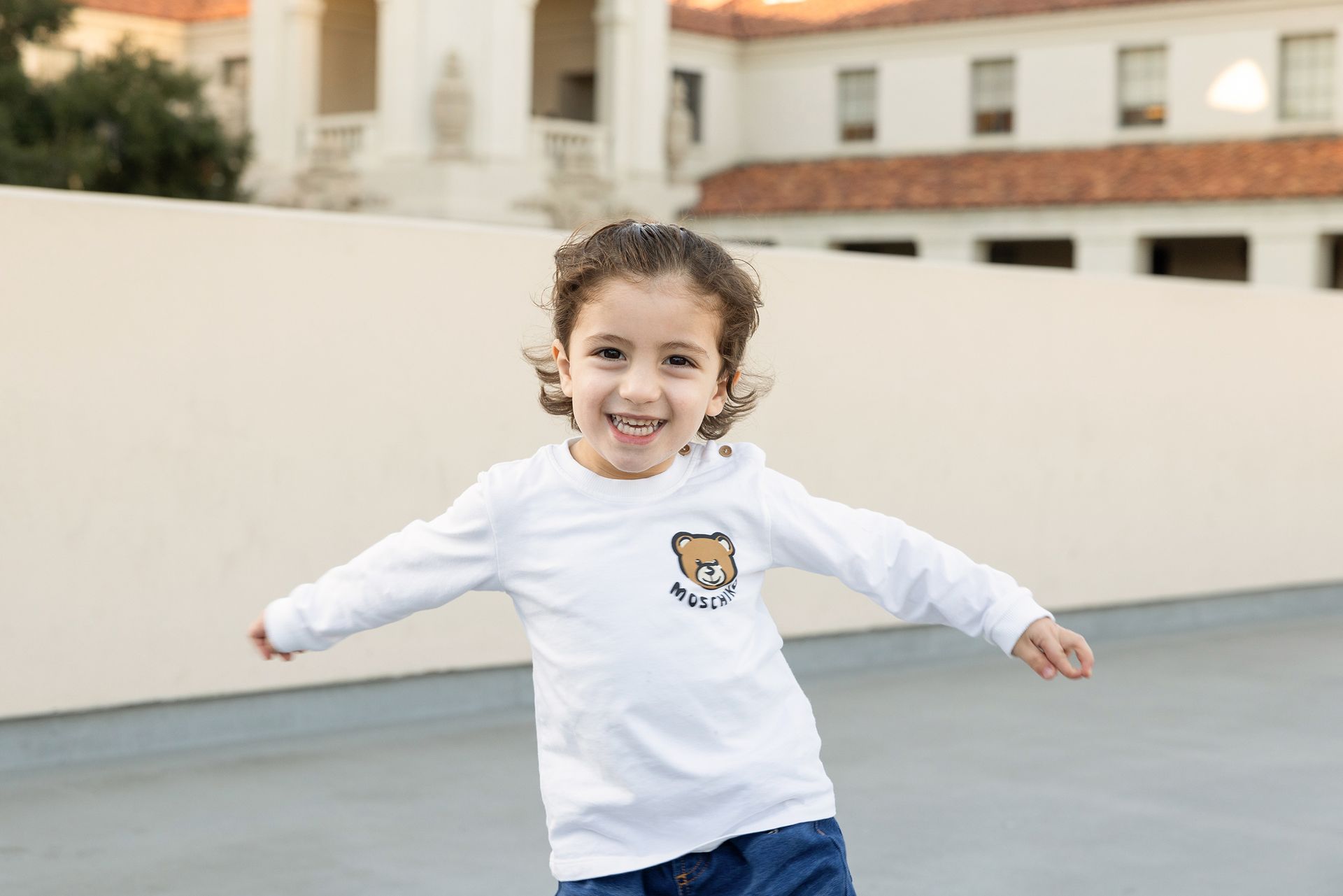 a boy is running toward camera with happy smile