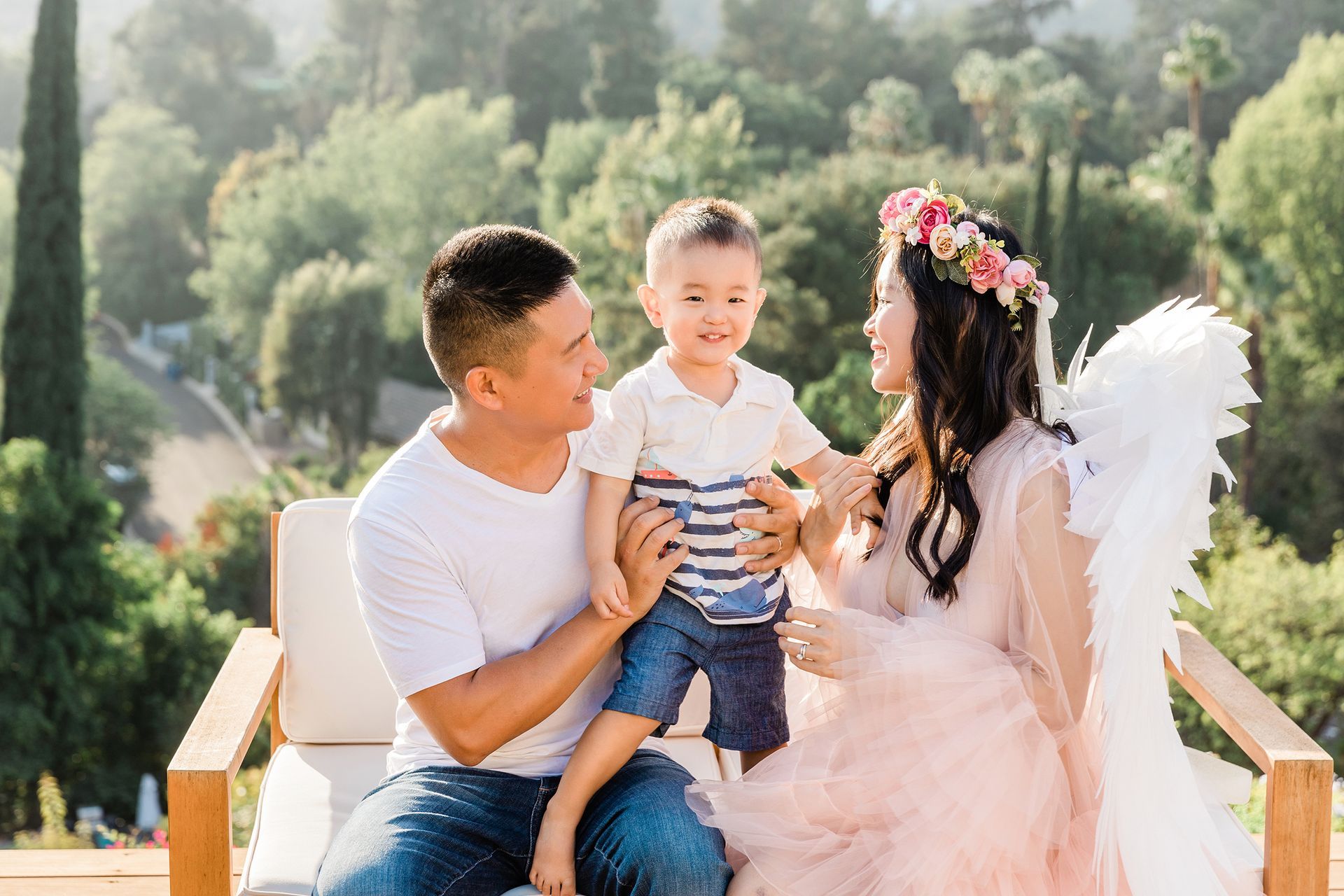 Asian family with their baby on sofa