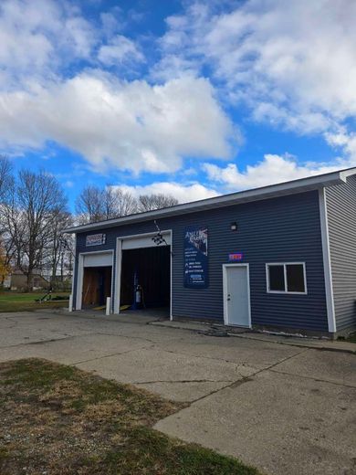 A garage with a blue sky and clouds in the background.