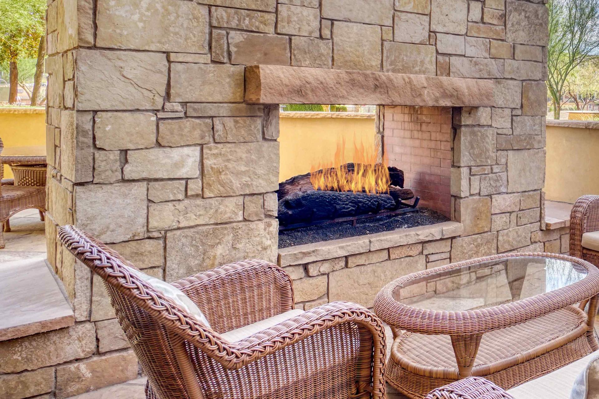 A custom fire pit installed in a brick wall