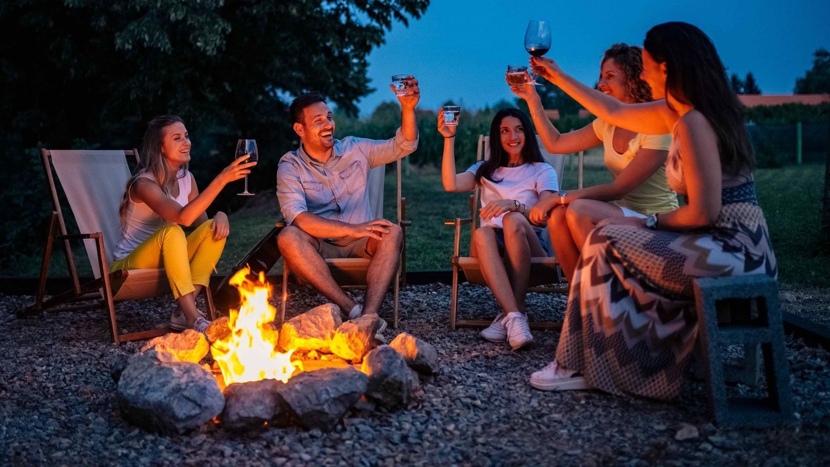 Friends gathering around a fire pit