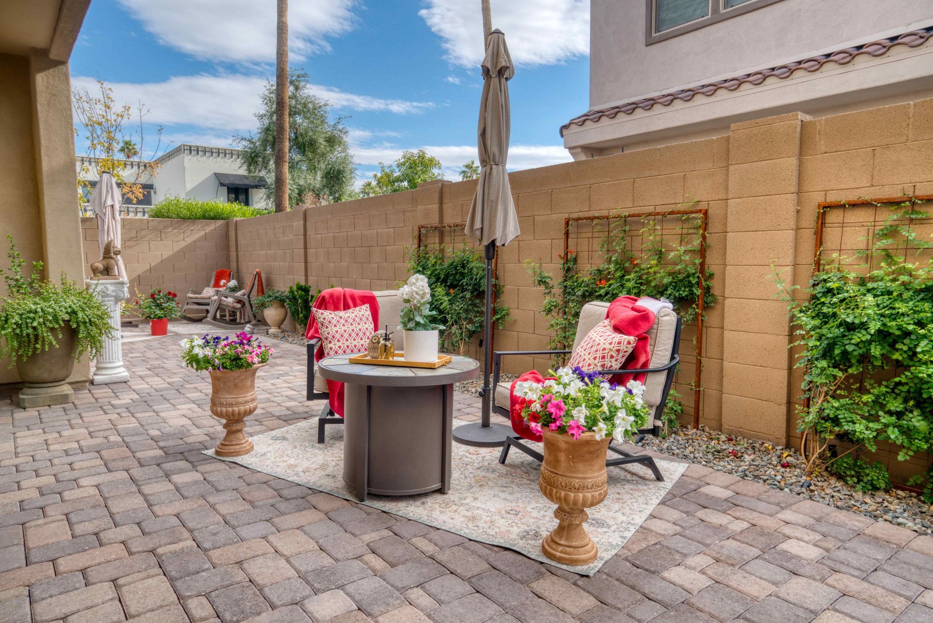 An outdoor seating area built on a paver patio