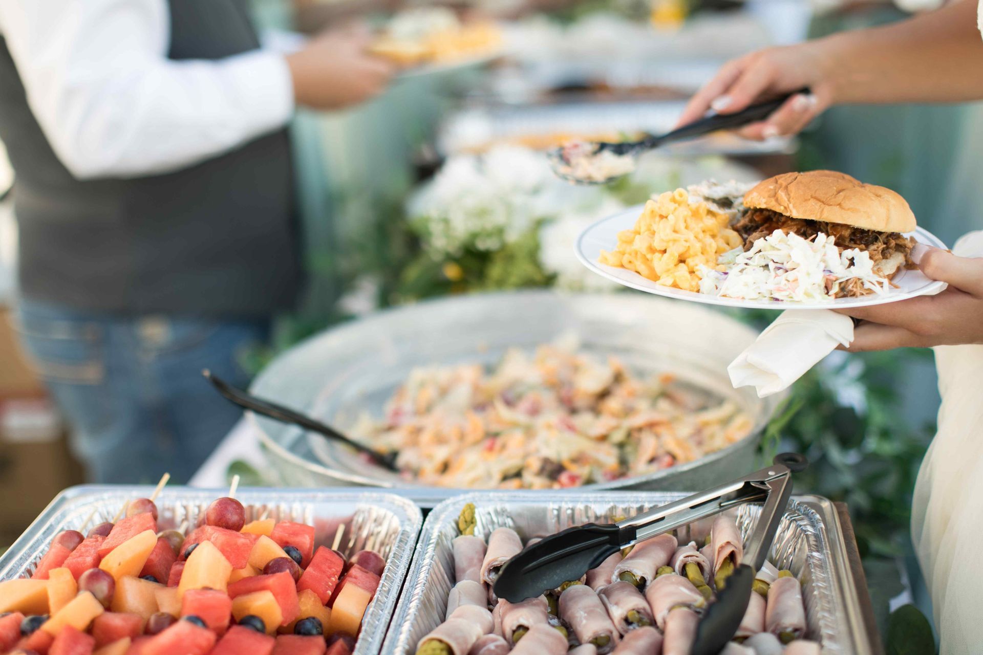 A buffet of food being served from an outdoor kitchen