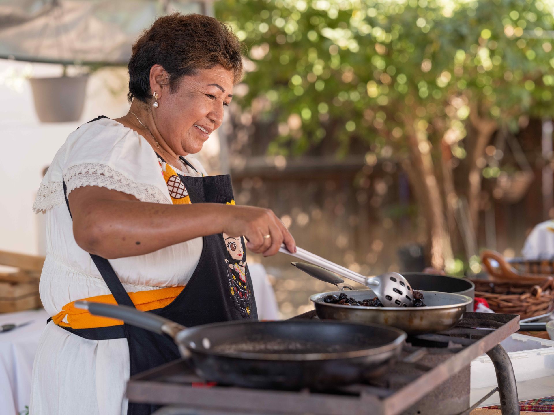 Cooking food in a frying pan over a BBQ grill