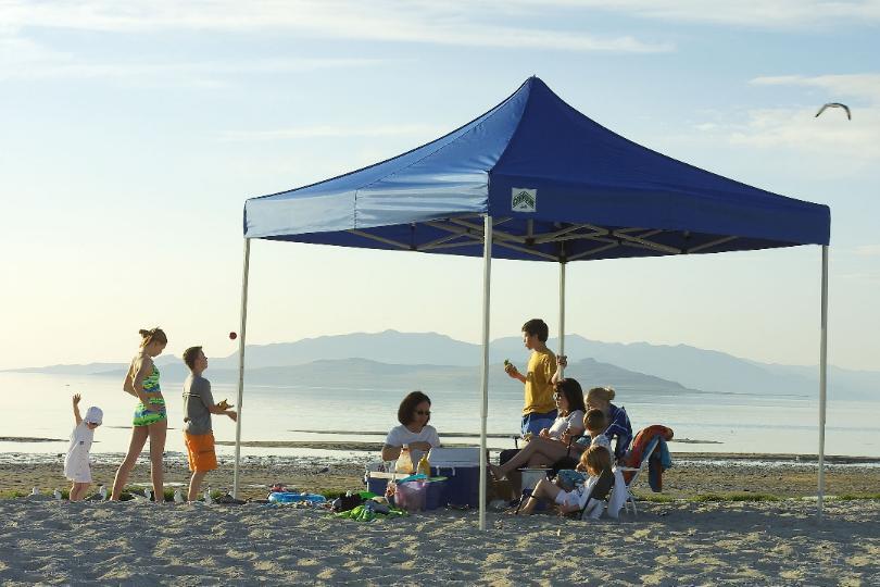 family under outdoor canopy on the beach