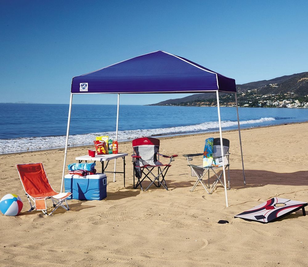 Folding chairs under metal canopy on the beach