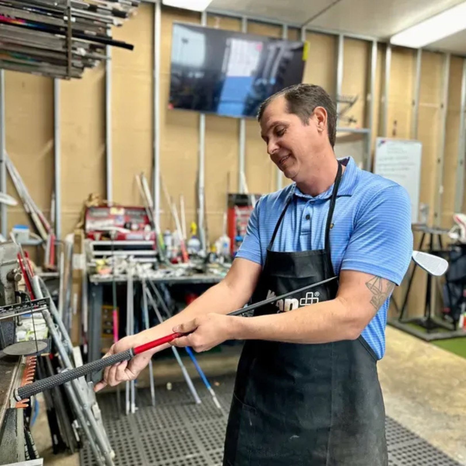 A black golf club headcover features an embroidered logo of a sugar skull wearing a sombrero over a golf club design.