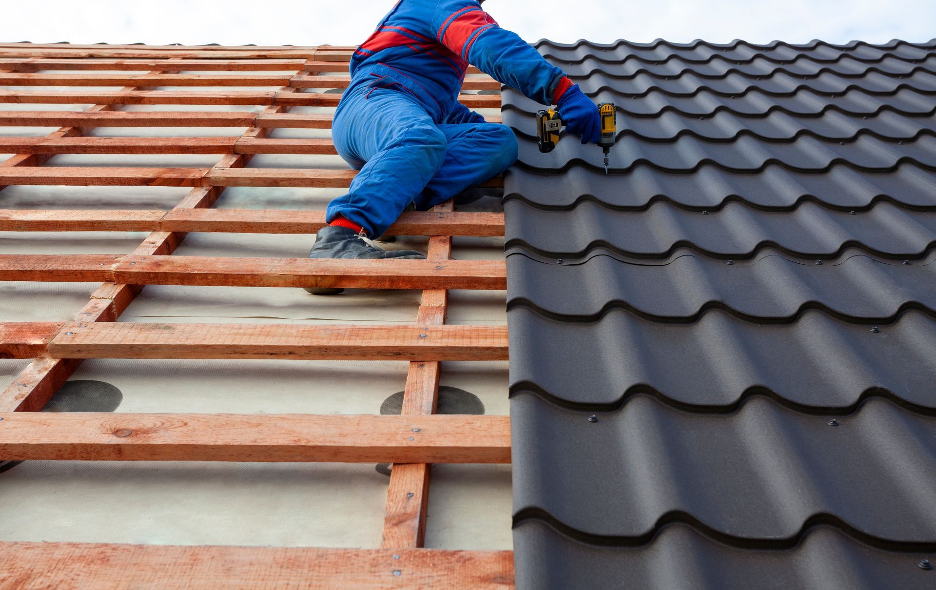 A man is working on the roof of a house.