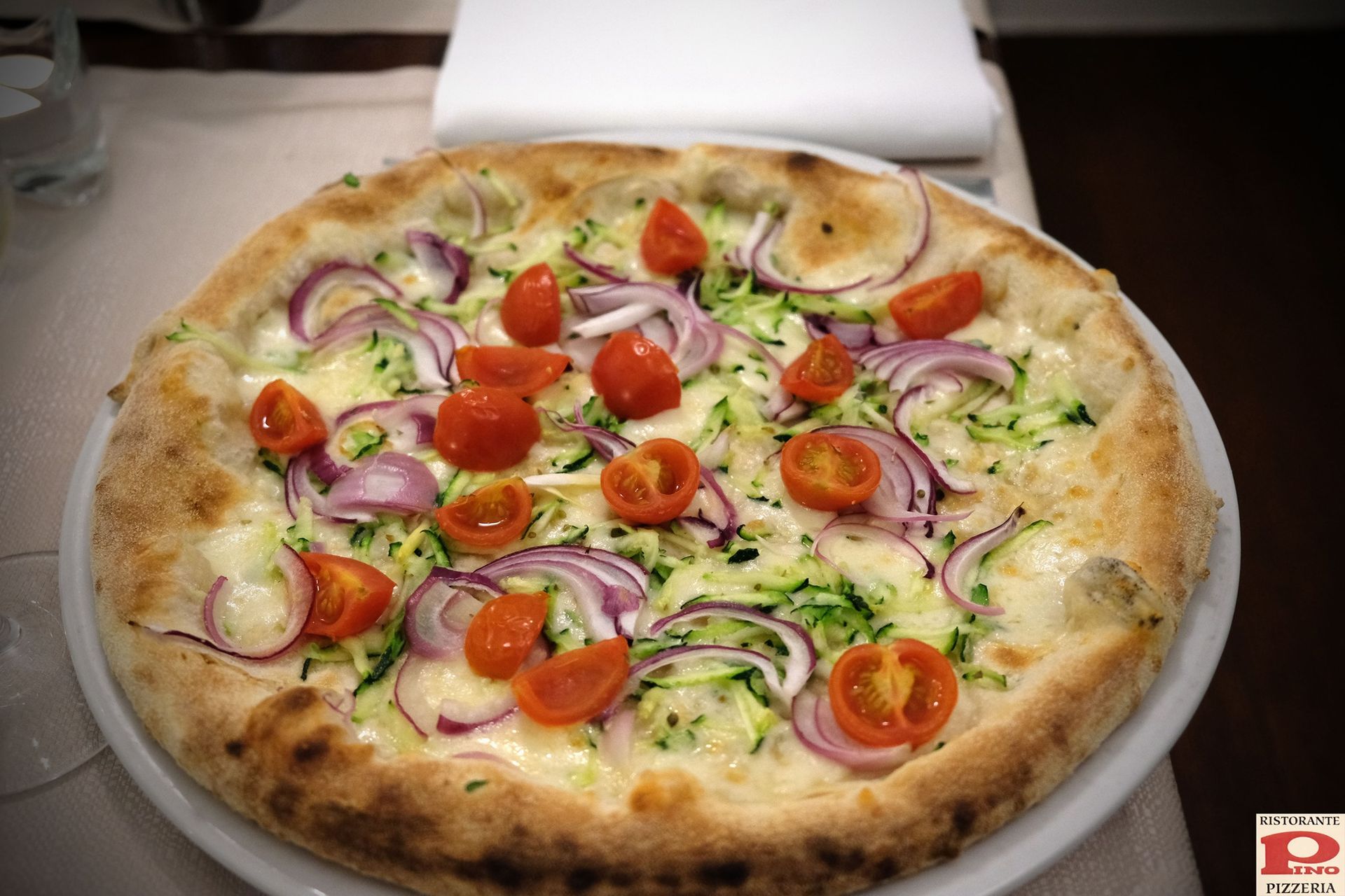 pizza con cipolla, verdure e pomodorini