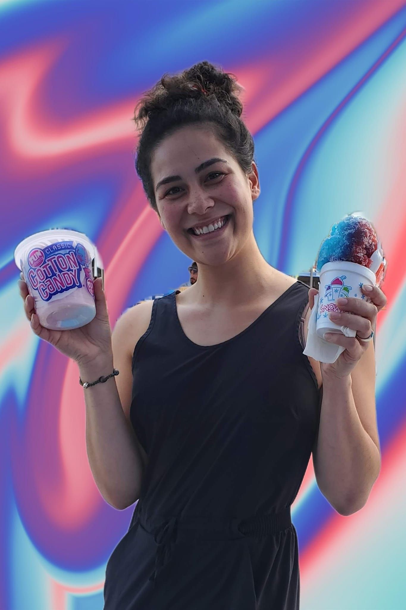 A woman in a black dress is holding two cups of ice cream.