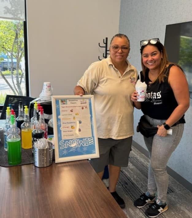 A man and a woman standing next to a sign that says snowple