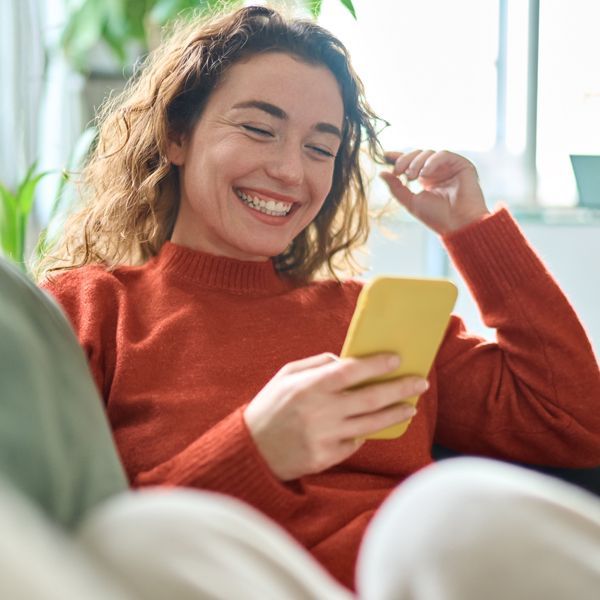 Woman on her cell phone Discovering More About Holistic Energy Bodyworks with a Free Energy Healing Consultation