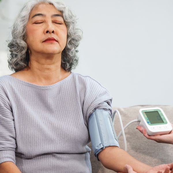 relaxed middle-aged woman testing her blood pressure management program