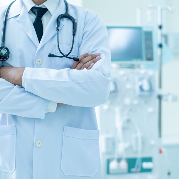 Traditional medical doctor standing by the dialysis machine. Traditional medical practices complement Kidney Disorder Energy Healing by Holistic Energy Bodyworks.