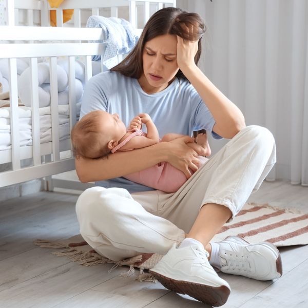 Woman with baby learning How Does Energy Healing Help Avoid and Minimize Postpartum Depression