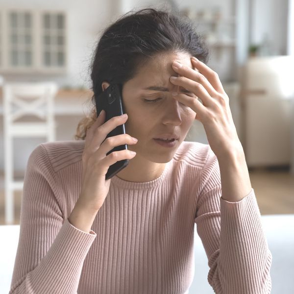 Woman on the phone. Contacting Holistic Energy Bodyworks for an Energy Healing Treatments Free Consultation