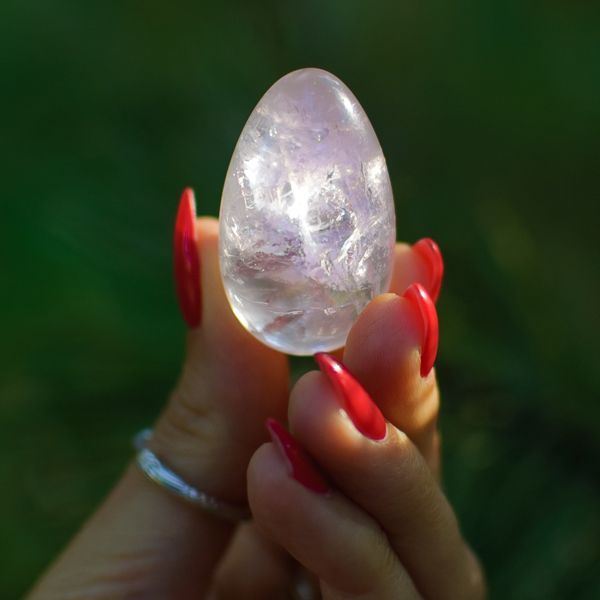 woman holding an egg-shaped crystal  for Infertility Energy Healing by Holistic Energy Bodyworks