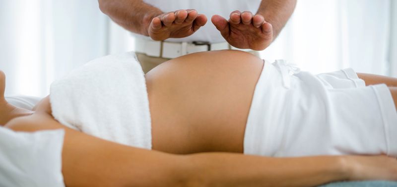 Woman receiving Pregnancy Energy Healing Support by Holistic Energy Bodyworks