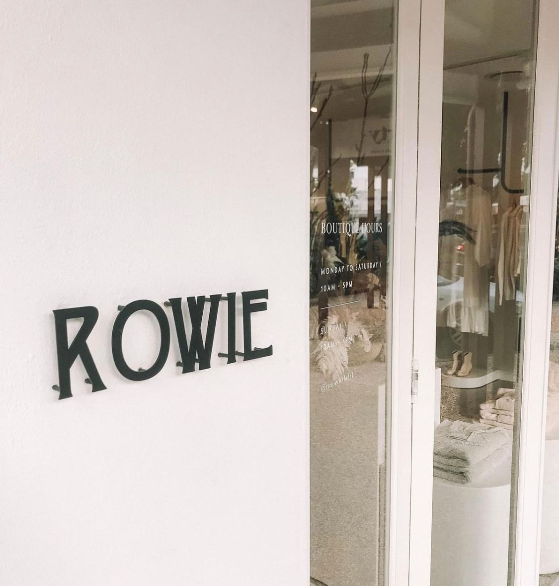 Rowie Sign Beside Store Entrance — Shogun Signs & Print