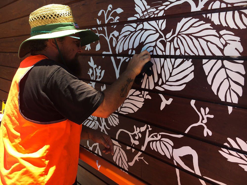 Team Adding a Sticker at the Wood — Custom Signs in Byron Bay NSW