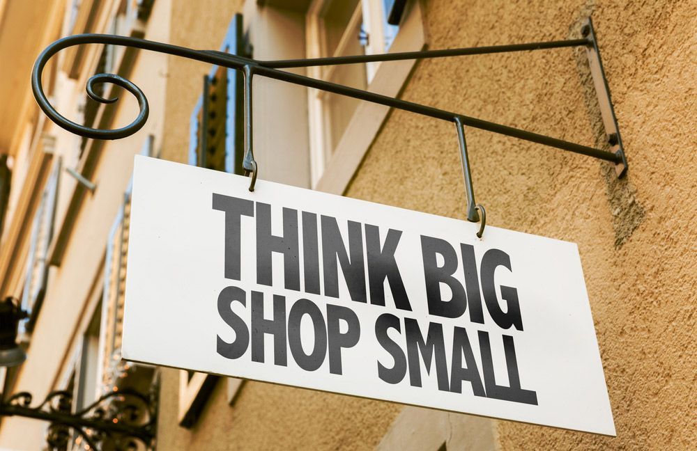 Sign on the Side of a Building That Says Think Big Shop Small — Shogun Signs & Print Pty Ltd in Byron Bay, NSW