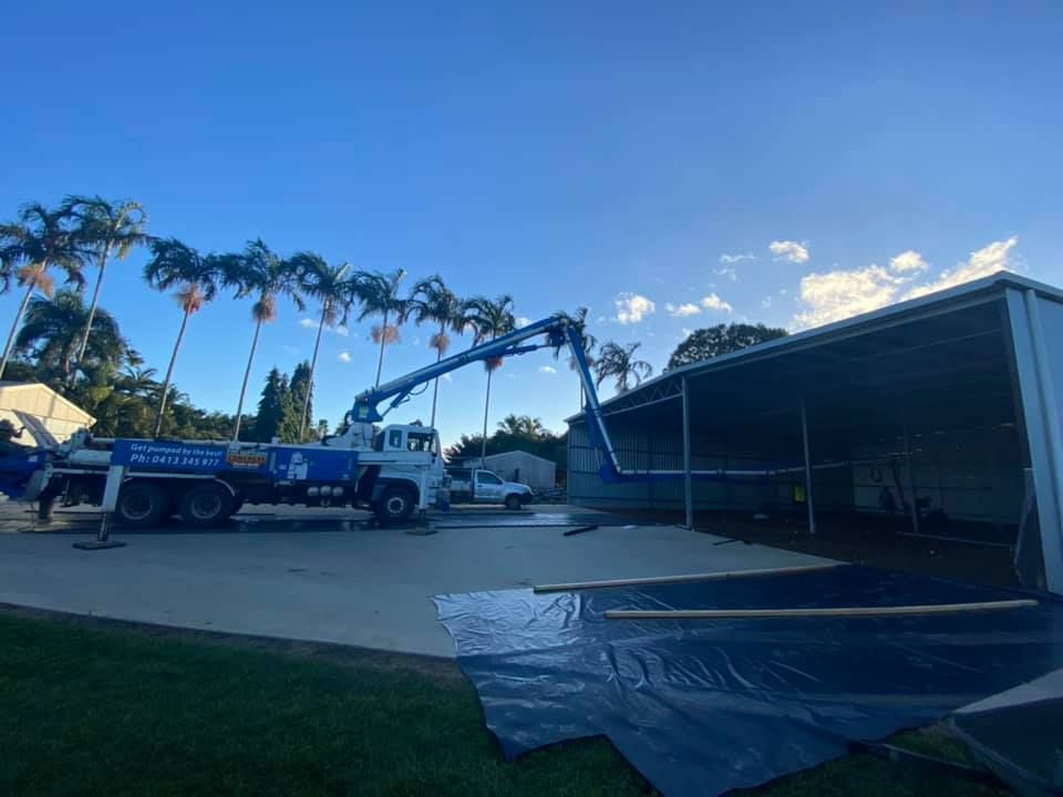 A Concrete Pump Truck is Pumping Concrete Into a Building — Far Northern Concrete Pumping in Cape York, QLD