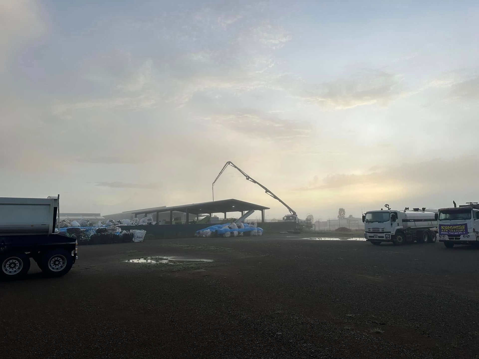 A Concrete Pump is Pouring Concrete Into a Building Under Construction — Far Northern Concrete Pumping in Tablelands, QLD
